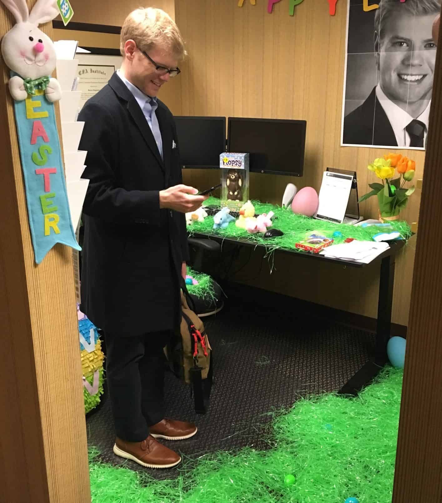 Spencer smiles as he discovers his cubicle has been changed into an Easter egg hunt